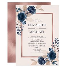 an elegant wedding card with blue flowers and gold foil on the front, along with a pink envelope