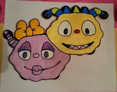 two paper plates with cartoon faces on them