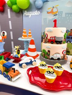 a birthday cake with cars and trucks is on display at the children's birthday party