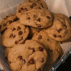 chocolate chip cookies in a basket on top of a table