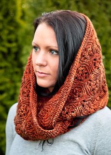 a woman wearing a knitted cowl scarf