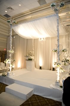 a wedding setup with white flowers and candles