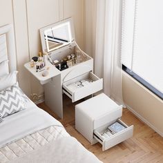 a bedroom with a bed, vanity and mirror on the wall next to a window