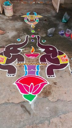 an elephant is painted on the ground with candles