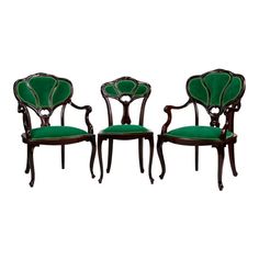 three chairs with green velvet upholstered back and seat cushions, one in the shape of an elephant's head