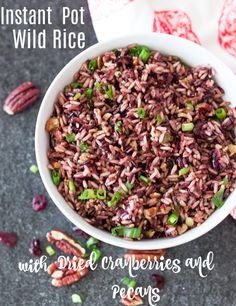 a bowl filled with wild rice next to pecans