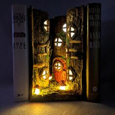 a bookend made out of wood and lit up with fairy lights