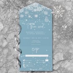 the snowflake wedding suite is on display in front of a marble background with silver ribbon