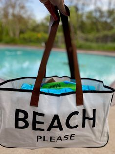 The perfect accompaniment to your trips to the shore, the lake or a weekend getaway - this "BEACH PLEASE" large canvas tote bag! It's perfect for carrying your seashells, beach reads, and other beach necessities. It's lightweight, durable, and stylish - you'll be prepared for any adventure! So grab your shades and your bag- BEACH PLEASE! Made of canvas and brown vegan leather 20" wide 11" tall 5" deep Beach Reads, Beach Necessities, Beach Please, Beach Reading, Weekend Getaway, Large Canvas, Be Prepared, Weekend Getaways, Canvas Tote Bag