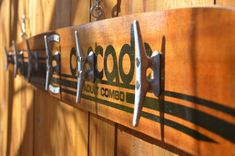 a close up of a wooden sign with metal handles on it's sides and the words colorado written in green