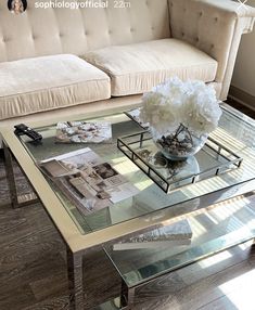 a glass coffee table with flowers on top