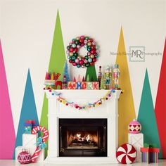 a decorated fireplace with christmas decorations and balloons on the mantel above it in front of multi - colored trees