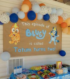 this is an image of a birthday party with balloons on the wall and decorations around it