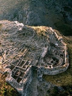 an aerial view of the ruins and surrounding mountains