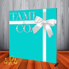 a blue box with a white bow and the words tami & co on it