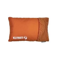 an orange pillow sitting on top of a white wall