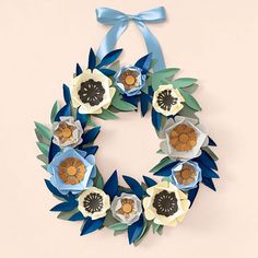 a paper wreath with blue and white flowers