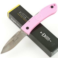 a pink knife sitting on top of a box next to it's openers