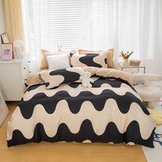 a bed with black and white designs on it