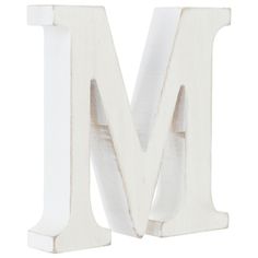 the letter m is made out of wood and has been painted white with some paint on it