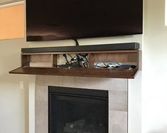 a flat screen tv mounted above a fireplace