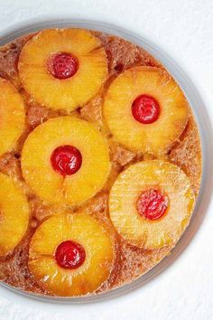 pineapple upside down cake with cherries on top in a glass dish, ready to be eaten