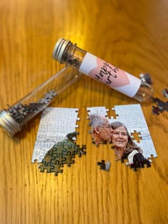 a piece of jigsaw puzzle next to a bottle with a photo on it