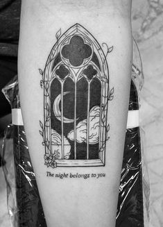 a black and white photo of a person's leg with a tattoo that reads, the night belongs to you