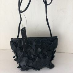 T Tahari 3d Greta Leather Flowers Small Crossbody Handbag Black Purse New, With Tags The Greta Leather Crossbody By T Tahari Features Beautiful, Dimensional Floral Appliques That Are Guaranteed To Turn Heads Top Snap Closure 1 Interior Zip Pocket Crossbody Strap Pebble Soft Genuine Leather Floral Applique Design Grained Finish Spot Clean Back Logo Lettering Accent Imported Measures Approx: H-5.5 X W-9.5"-6" X D-4.5" Strap-27" (Not Adjustable And Not Removable) Bag Mini Size ,But Very Spacious. Black Leather Evening Bag With Adjustable Strap, Leather Pouch Evening Bag For Party, Textured Leather Shoulder Bag For Party, Leather Evening Shoulder Bag With Phone Holder, Party Shoulder Bag In Textured Leather, Leather Evening Bag With Adjustable Strap For Party, Modern Textured Leather Party Shoulder Bag, Soft Leather Crossbody Bag For Party, Leather Shoulder Bag For Party