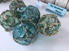 some balls are wrapped in twine and have been placed on the table for display