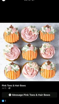 cupcakes with pink frosting and flowers on them are arranged in the shape of pumpkins