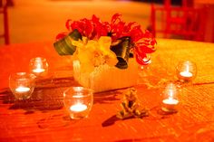 flowers and candles are sitting on a table