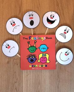 the feelings book is surrounded by paper plates with faces on them, and an orange book cover