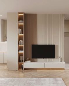 a living room with a large tv on top of a white entertainment center in front of a wooden wall