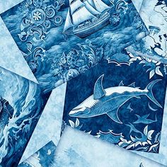 several blue and white designs on paper with an image of a boat in the ocean