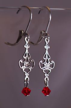 Victorian style earrings with 4 mm Swarovski Red crystals. The Earring are 1 1/2 inches long. Elegant Red Single Clip-on Earring, Red Handmade Dangle Crystal Earrings, Red Handmade Crystal Dangle Earrings, Handmade Red Crystal Dangle Earrings, Handmade Red Crystal Drop Earrings, Red Jewelry For Pierced Ears As A Gift, Red Metal Drop Earrings, Red Sterling Silver Single Earring, Single Red Sterling Silver Earring