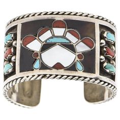 This beautiful bracelet is by Zuni artists Filbert & Clara Gasper. Circa 1960 - 1970. The bracelet is sterling silver with inlay turquoise, mother of pearl and coral. In the center is an inlaid face and on the sides there are additional bezel set turquoise and coral pieces. The next session has inlay mother of pearl rectangles. The piece has a 1" area to get your wrist into. Interior cuff length is 6.75". Filbert and Clara Gasper are highly recognized and noted Zuni artists that are known for th Pear Cut Sapphire Ring, Blue Diamond Necklace, Ancient Coin Jewelry, Pear Cut Diamond Ring, Gold Diamond Watches, Turquoise And Coral, Native American Turquoise, Coin Jewelry, Coral Turquoise