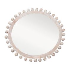 a round mirror with white balls on it