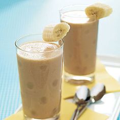 two glasses filled with smoothie and banana slices