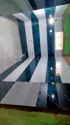 an empty room with black and white stripes on the floor