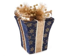 a blue and gold wrapped gift box with golden decorations on the top, sitting in front of a white background