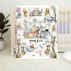 winnie the pooh and friends baby blanket on a crib next to a potted plant