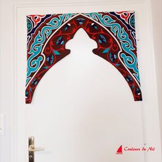 the door is decorated with red, blue and white designs