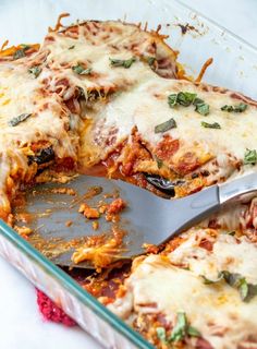 a casserole dish filled with lasagna and cheese