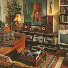 a living room filled with lots of furniture and audio equipment in front of a tv