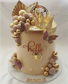 there is a cake decorated with gold and purple decorations on the bottom layer, as well as a crown