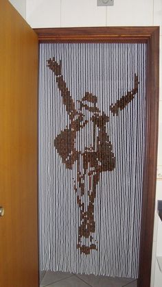 the door is made out of strips of wood and has an image of a flower on it