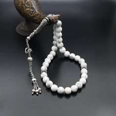 Natural Howlite Gemstone Tasbih, 925 Sterling Silver Prayer Beads, Turkish Prayer 33 Beads, Rosary, Tasbih, Tesbih, Tasbeeh, Tasbih 33 ✦ Details ✦ * Material: 925 Sterling Silver * Gemstone: Howlite  * Silver weight: 15.30 grams * Bead : 33 Count * Bead Size: 10 mm * Total Length :34 cm (13.38 Inches) ✦ Shipping ✦ * Processing time: 1-2 business days. * This item ships from my Turkish workshop in Istanbul. * Add your phone number in address box for a smoother delivery. That makes courier personnel's job easier.  ✦ Packaging ✦ * Comes with a luxury gift box and a jewellery cleaning cloth. White Polished Beads Gems And Cabochons For Gifts, White Round Beads For Gifts, Spiritual Silver Beads With Natural Stones, Silver Rosary With Natural Stones And Round Beads, Silver Rosary With Natural Stones, Spiritual Silver Polished Beads, Gems, And Cabochons, Silver Polished Beads For Spiritual Use, Spiritual Silver Polished Beads, Rain Accessories