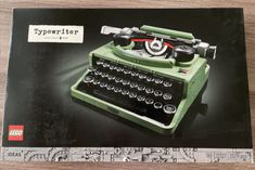 an old fashioned typewriter sitting on top of a wooden table