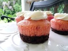 three cupcakes sitting on top of a white plate